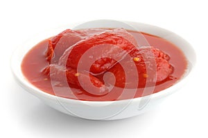 Whole canned tomatoes in white dish.