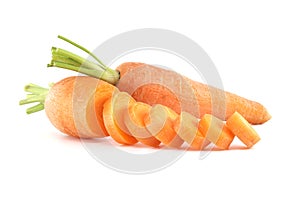 Whole carrot alongside its sliced pieces over white background