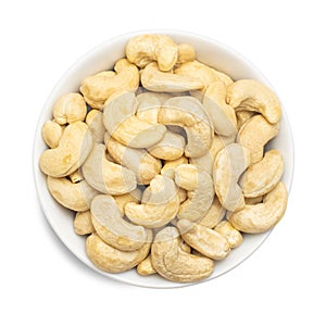 Whole cashews in bowl isolated on white background. Top view