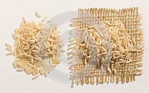 Whole Chinese Rice seed. Close up of grains spreaded over white photo