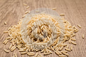 Whole Chinese Rice seed. Pile of grains on the wooden table. Selective focus.