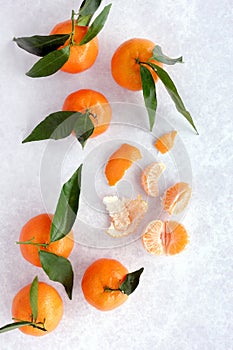 Whole Clementines with Leaves, Peel and Segments. Vertical Version