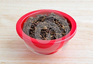 Whole cloves in a red dish on counter