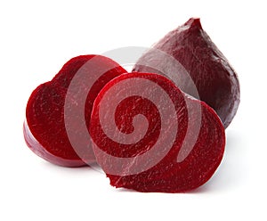 Whole and cut boiled red beets on white