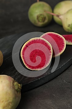Whole and cut fresh turnips on grey table, closeup