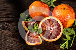 Whole and cut ripe juicy Sicilian Blood oranges