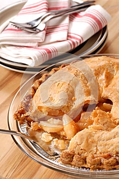 Whole deep dish apple pie with a flaky crust