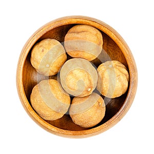 Whole dried limes, noomi basra, limoo amani, loomi, in wooden bowl photo