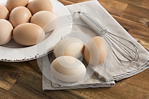 Whole eggs in bowl, whisk, napkin.