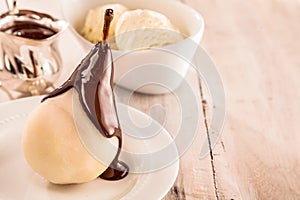 Whole fresh pears called Birne Helene with chocolate and ice-cream