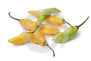 Whole fresh raw ripe yellow and green Madame Jeanette pepper close up on white background