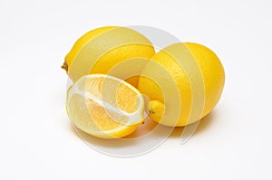 Whole fruit and half fresh lemon on white background