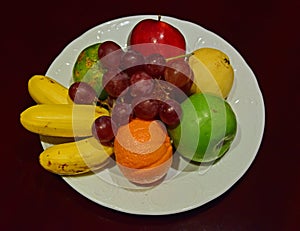 Whole Fruit Platter on White Plate on Wooden Table