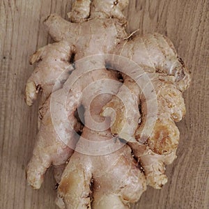 Whole ginger on the wooden table.
