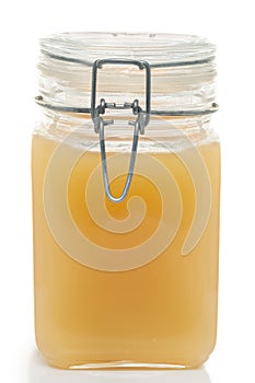 Whole glass honey jar macro isolated white background