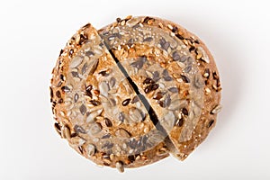 Whole grain bread with seeds sliced on the wooden cutting board. white background. top view. close-up view