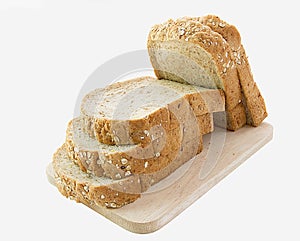 Whole grain bread slices on wooden cutting board