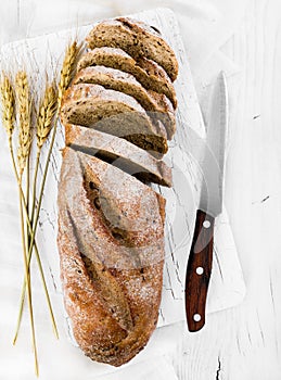 Whole grain bread on wooden background