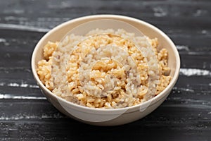 Whole grain brown rice cooked in small bowl