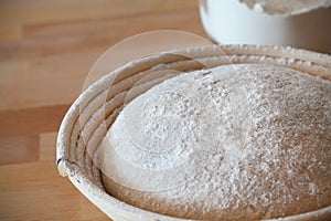 Whole-grain dough proofing in a baneton basket photo