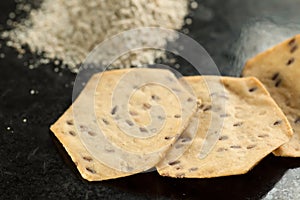 Whole grain organic cracker and flour on the black