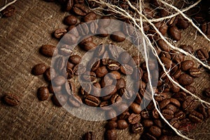 Whole grains of coffee on burlap. The aroma of coffee