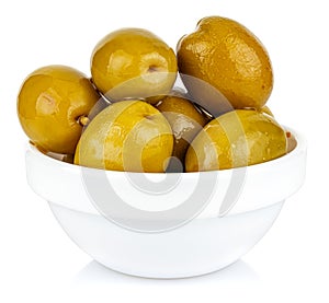 Whole green olives in a small white ceramic round bowl isolated on white background