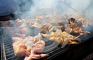 Whole grilled chicken on charcoal during Madeira Carnival