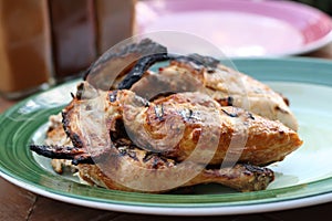 Whole grilled chicken on plate