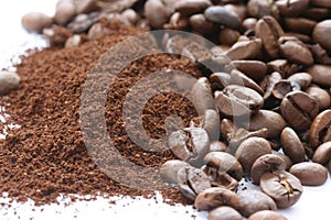 Whole and ground coffee beans scattered photo