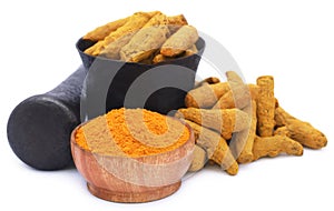 Whole and ground turmeric with mortar and pestle