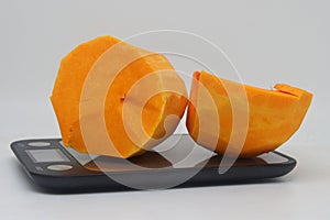 whole and half butternut squash isolated on white background. Slices of pumpkin on a white background, close-up.