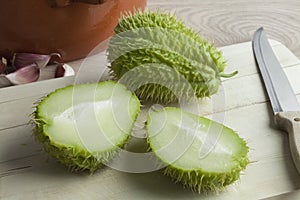 Whole and half fresh spined chayote fruit photo