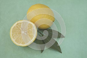 Whole and half lemon with leaves