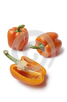 Whole and half orange bell peppers