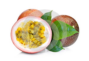 Whole and half of passion fruit with green leaves isolated