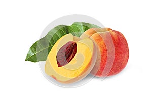 Whole and half peach with stone and leaf isolated