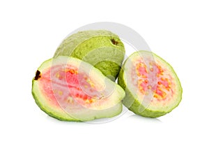 Whole and half pink guava fruit isolated on white