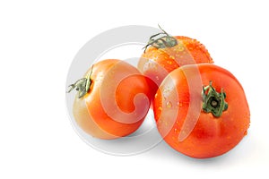 Whole and half red tomato with green leaf isolated on white background