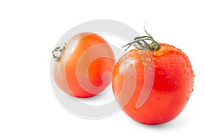 Whole and half red tomato with green leaf isolated on white background