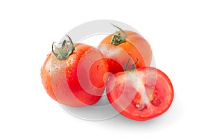 Whole and half red tomato with green leaf isolated on white background