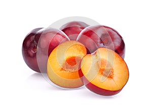 Whole and half with slice of red cherry plums isolated on white