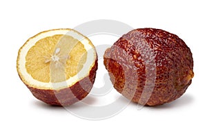 Whole and halved fresh Citrus limon Rosso close up on white background photo