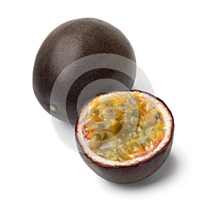 Whole and halved fresh passion fruit close up on white background