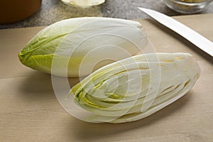 Whole and halved fresh raw Belgian endive