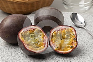 Whole and halved fresh tropical passion fruit close up