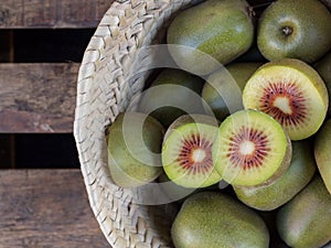 whole and halved kiwis with red interior