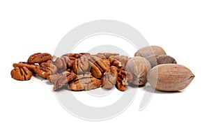 Whole and halved pecans on white