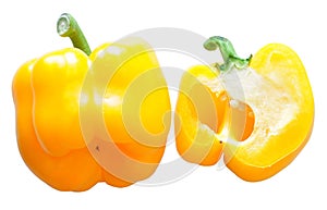 Whole and halved Yellow Capsicum isolated on white background