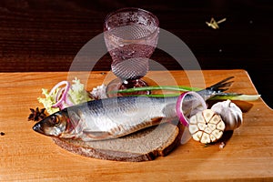 whole herring, onion rings, garlic, bread, vodka